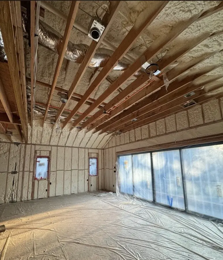 Interior walls and ceiling insulated with spray foam during new construction in Longmont